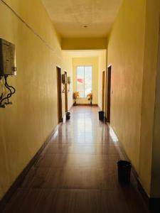an empty hallway of a building with a large window at Black Forest Hotel in Kalām +1 photo
