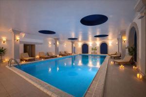 a pool in a hotel with chairs and a swimming pool at Panorama Apartment in Trieste