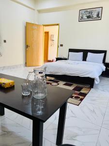 a room with a bed and a table with a bed at Black Forest Hotel in Kalām