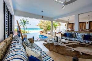a living room with a couch and a view of the ocean at Tequila Sunrise Pool Cabana-Diani Beach in Diani Beach