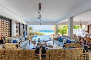 a living room with couches and a view of the ocean at Tequila Sunrise Pool Cabana-Diani Beach in Diani Beach