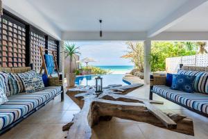 a living room with two couches and a pool at Tequila Sunrise Pool Cabana-Diani Beach in Diani Beach