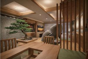 a room with a table and a tree in it at Hotel MAISAKURA MIYABI in Nara