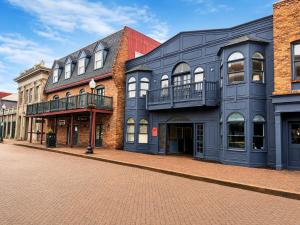 a row of buildings on a brick street at The Rustic Revival - Charming 2BR Retreat in St. Charles +9 photos