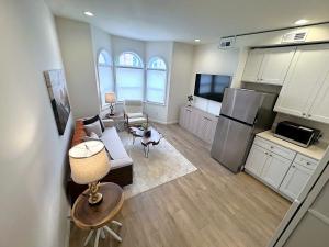 a living room with a couch and a kitchen at The Rustic Revival - Charming 2BR Retreat in St. Charles