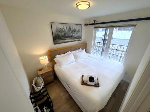 a bedroom with a bed with a tray on it at The Rustic Revival - Charming 2BR Retreat in St. Charles