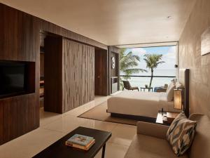 a bedroom with a bed and a view of the ocean at Alila Seminyak in Seminyak