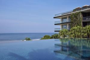 a hotel with a swimming pool in front of the ocean at Alila Seminyak in Seminyak +127 photos