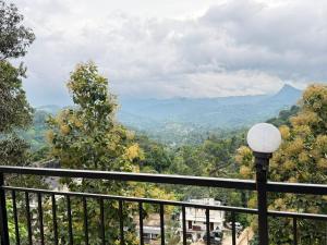 a view of the mountains from a balcony at Happy Days by 3R Munnar in Munnar