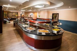 a buffet line with a lot of food at Elilly International Hotel in Addis Ababa