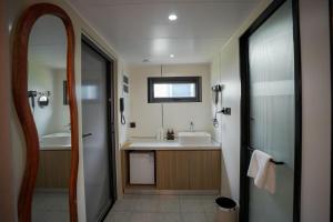 a bathroom with a sink and a mirror at Sea Side Resort in Paje +32 photos