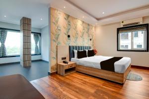 a bedroom with a large bed and a couch at Palette Dumdum Airport Formerly Seventy-Seven in Dum Dum +44 photos