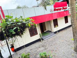 a building with a happy bar sign on it at Happy Days by 3R Munnar in Munnar +2 photos