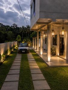 a car parked in front of a house with lights at Atithya Retreat in Hikkaduwa