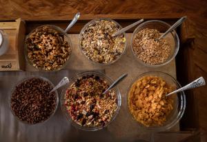 a group of four bowls of different types of cereal at Gästehaus -Pension Edelweiss in Vent +16 photos