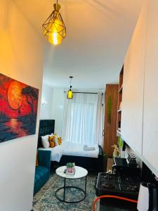 a small living room with a bed and a table at Suite Life in Kiambu