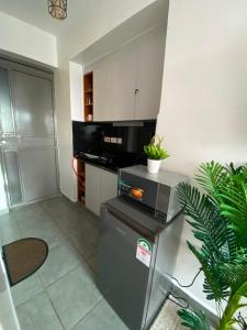 a kitchen with a refrigerator and a microwave at Suite Life in Kiambu +7 photos
