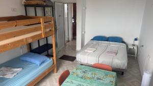 a bedroom with two bunk beds and a chair at 7 Calcosas in Valverde