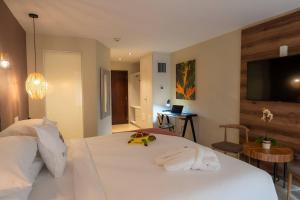 a bedroom with a white bed with a flat screen tv at Hotel El Panama by Faranda Grand, a member of Radisson Individuals in Panama City