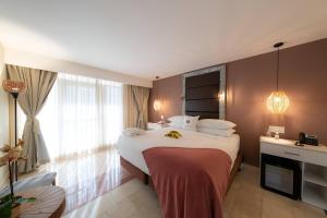 a hotel room with a large bed and a window at Hotel El Panama by Faranda Grand, a member of Radisson Individuals in Panama City