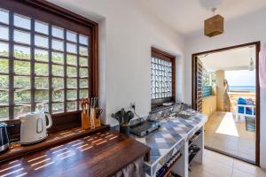 a kitchen with a counter top and a window at Tequila Sunrise Sky Cabana-Diani Beach in Diani Beach