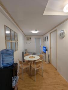 a living room with a table and chairs and a room at REI365 Condotel in Davao City