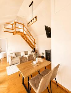 a living room with a table and a couch at Dor de Munte in Vărtăneşti