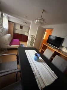 a living room with a table with a bowl on it at Souterrain Zimmer mit Sauna in Klosterlechfeld
