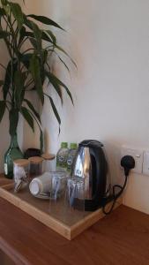 a toaster sitting on a wooden table with a plant at Kadura Resort in Ella
