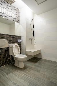 a bathroom with a toilet and a sink and a shower at Krungthai Hotel at Rangnam in Sathani Sam Sen +14 photos