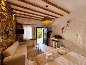 a living room with a couch and a table at Atlazia Suites in Alinda