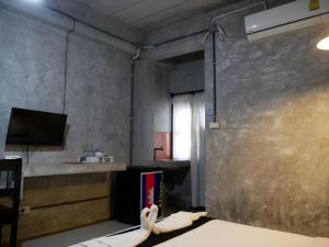 a room with a kitchen with a sink and a window at 41Studio in Nakhon Phanom