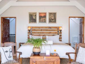 a bedroom with two beds and a table at L'abri in Langebaan +21 photos