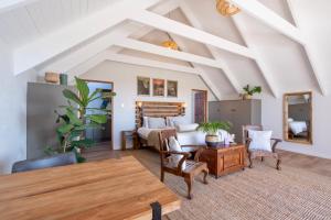 a living room with a bed and a table at L'abri in Langebaan