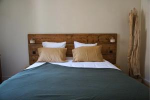 a bedroom with a large bed with two pillows at Maison Constant - L'Erable in Autun +7 photos