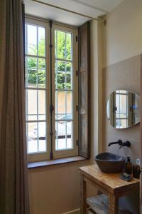 a bathroom with a sink and a window at Maison Constant - L'Erable in Autun