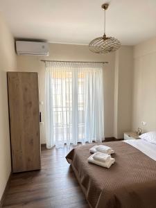 a bedroom with a bed with two towels on it at Nikoletta in Katerini