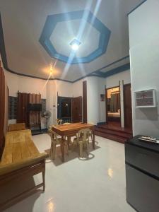 a dining room with a table and a ceiling at Camiguin El Rio Dorado in Catarman