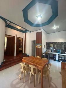 a dining room with a wooden table and chairs at Camiguin El Rio Dorado in Catarman +9 photos