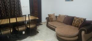 a living room with a couch and a chair at Axiom Services in Katamanso