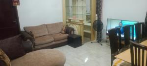a living room with a couch and a man in the mirror at Axiom Services in Katamanso
