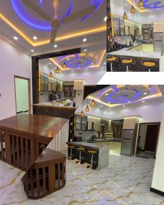 a kitchen with a bar with blue lights on the ceiling at A&T villa in Jaffna