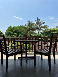 a table and two chairs sitting on a patio at Sri Residence in Kamburugamuwa