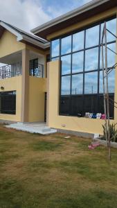 a house with a large window on the side of it at Hidden Gem KAG Kitengela in Stony Athi