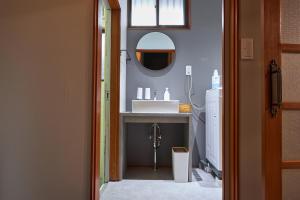 a bathroom with a sink and a mirror at Wan Kumano by WhyKumano in Nachikatsuura +19 photos