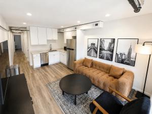a living room with a couch and a table at The Brick & Beam 3rd Floor Apartment in St. Charles