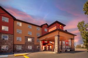 a hotel with a building with a clock tower at Comfort Inn & Suites Red Deer - Highway 11 in Red Deer