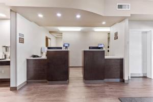 an office with two reception desks with computers on them at Comfort Inn & Suites Red Deer - Highway 11 in Red Deer +74 photos