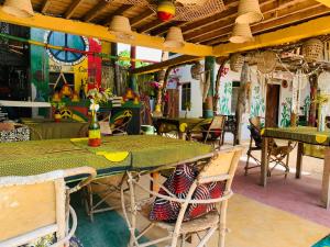 a table and chairs in a restaurant with graffiti at Peace House Zanzibar in Bwejuu