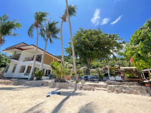 a house on the beach with palm trees at Big Fish Resort Koh Tao in Ko Tao